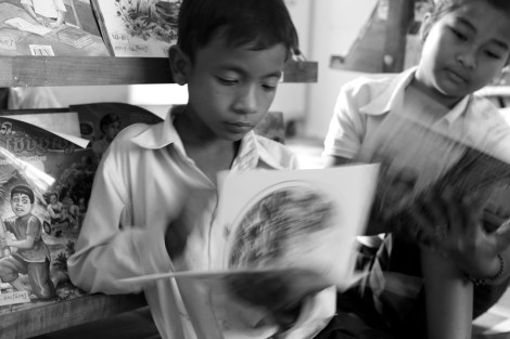 Chan Chao Loy (or ‘Loy’, left), a 12 year old waste picker is reading books in a school library which was donated by Room To Read. Being a fond of reading books and a bright child as well, his record is very high in a school. He is attending 4th grade as of 2013. (Photo © Lee Yu Kyung 2013) 