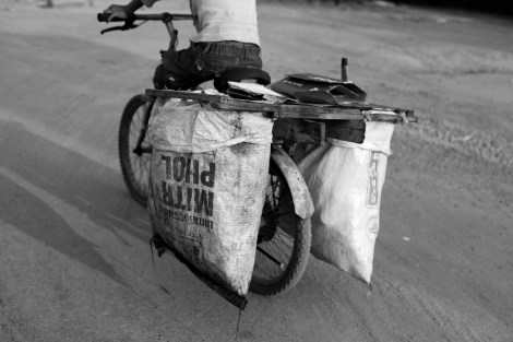 A 12 year old boy, Chan Chao Loy (or ‘Loy’) is driving his brake-broken bicycle during work. He is one of thousands waste picking children in Cambodia. Ever since he started to work, Loy has never skipped any single day for work, which starts from around 4 am for about 3-4 hours if his school time is set for after noon. If his classes are set in the morning, he works after school. (Photo © Lee Yu Kyung 2013) 