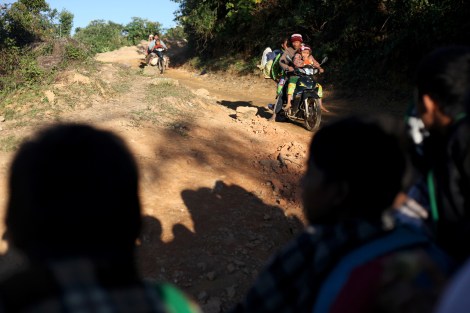 The fleeing Kachin IDPs by a rickety truck bumping along a cliffyside dirt road (Photo © Lee Yu Kyung)