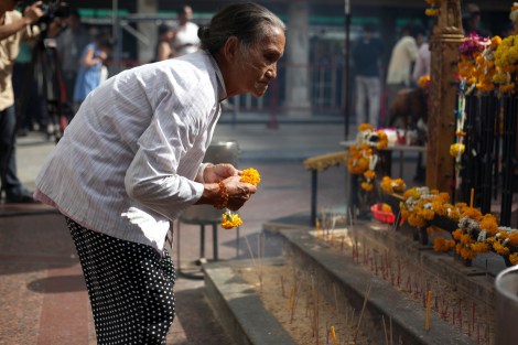 Gi Gwo Lian (70) is Myanmar citizen of Chinese origin. She came to Bangkok on August 17, the day of deadly bomb blast. 2 days later as Erawan Shrine reopened, she came to pray for victims. (© Lee Yu Kyung) 